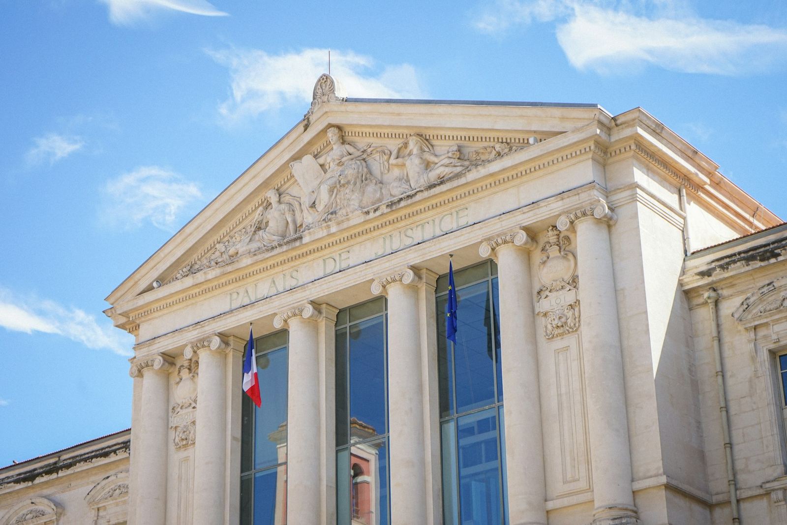 Colonnaded courthouse, French flag on the façade